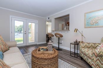 A living room with a couch and a table and a door